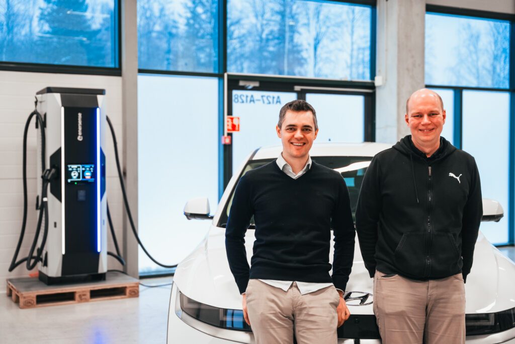 Enersense employees in front of the high power charging station